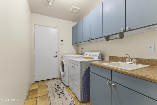 washroom with washer and dryer, sink, and cabinets