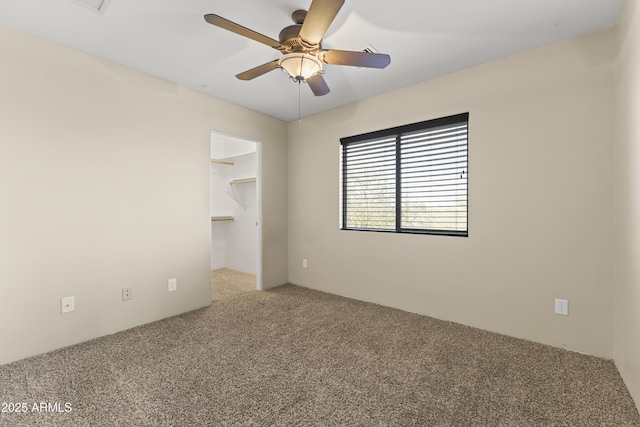unfurnished room featuring carpet and ceiling fan