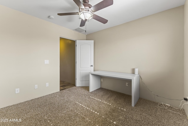 interior space with ceiling fan and carpet flooring