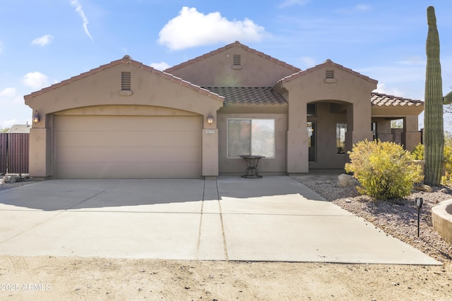 mediterranean / spanish-style house with a garage