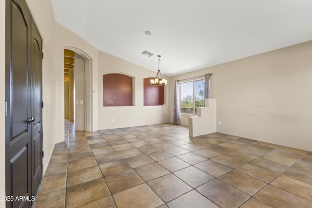 unfurnished room with tile patterned floors, vaulted ceiling, and a notable chandelier