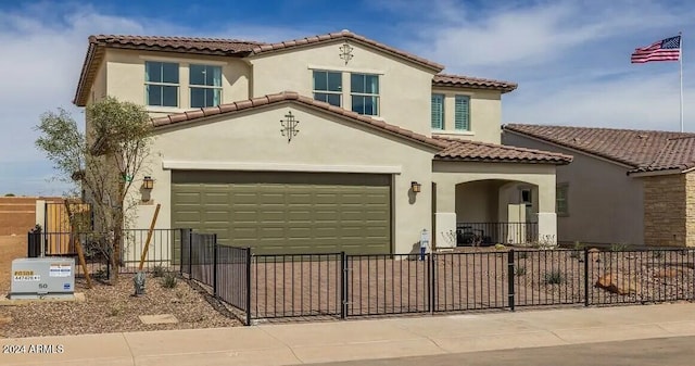 mediterranean / spanish-style house with a garage