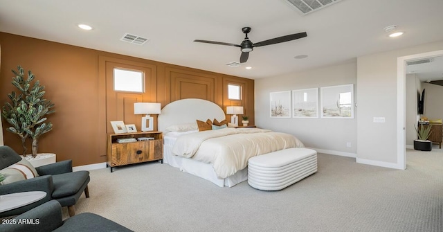 bedroom with ceiling fan and light colored carpet