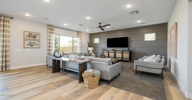 living room with ceiling fan and light hardwood / wood-style floors