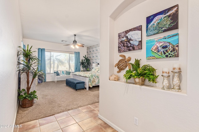 bedroom featuring light colored carpet and ceiling fan