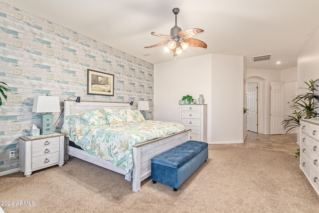 bedroom featuring light carpet and ceiling fan