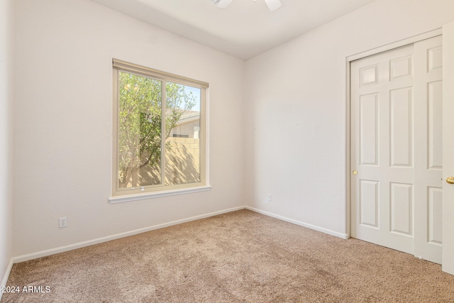 carpeted empty room with ceiling fan