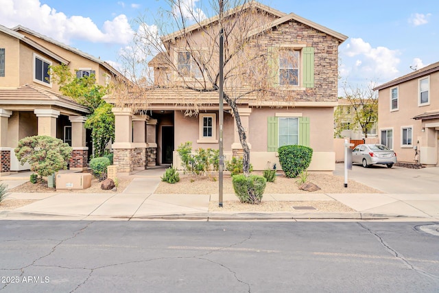 view of front of home featuring stone siding and stucco siding