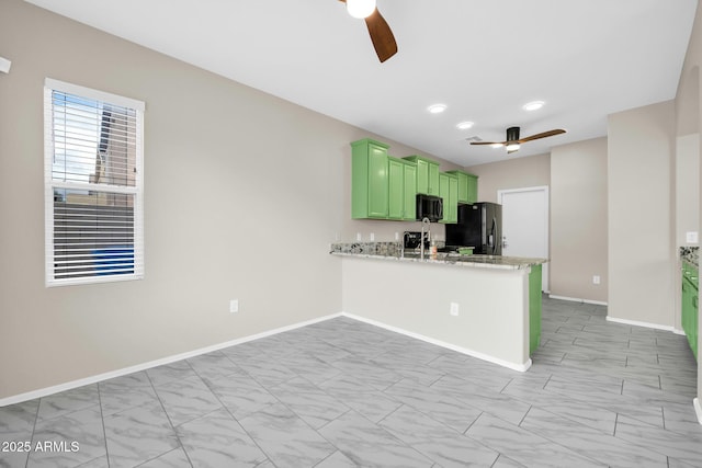 kitchen featuring baseboards, a peninsula, ceiling fan, black appliances, and green cabinets