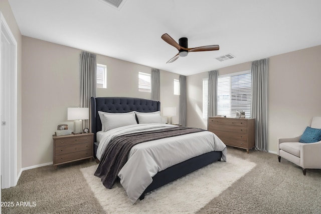 bedroom with visible vents, baseboards, light colored carpet, and ceiling fan