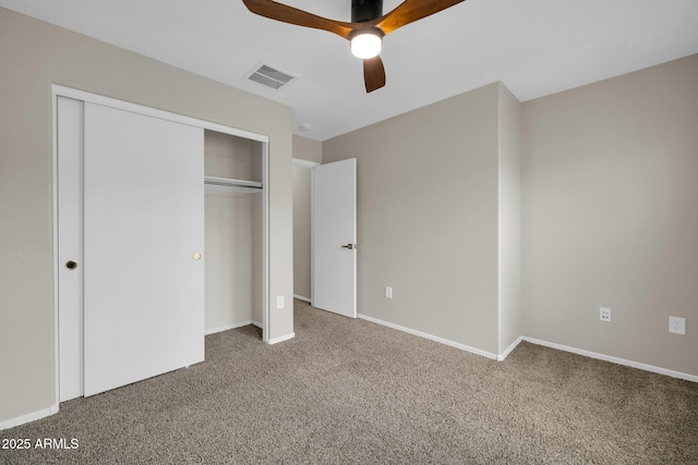 unfurnished bedroom featuring visible vents, a ceiling fan, a closet, carpet flooring, and baseboards