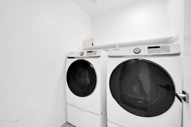 clothes washing area with independent washer and dryer and laundry area