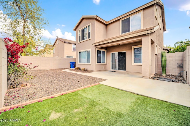 back of property featuring stucco siding, a fenced backyard, and a patio area