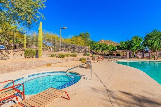 community pool featuring a patio and fence