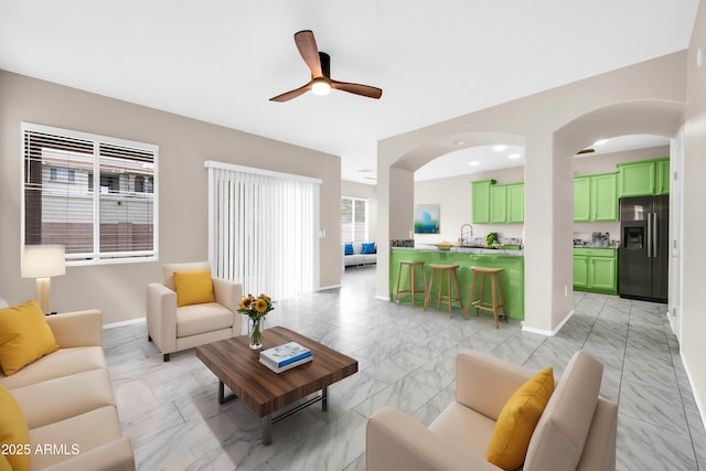 living room with marble finish floor, recessed lighting, arched walkways, baseboards, and ceiling fan