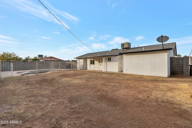 rear view of house featuring a yard and central air condition unit