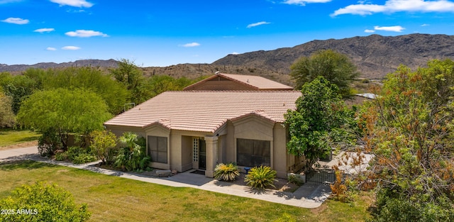 2311 W Dobbins Rd, Phoenix, AZ 85041 - view of front of home featuring a tile roof, a mountain view, a front yard, and stucco siding