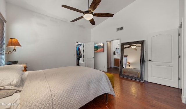 2311 W Dobbins Rd, Phoenix, AZ 85041 - bedroom with high vaulted ceiling, wood finished floors, a walk in closet, a closet, and ceiling fan