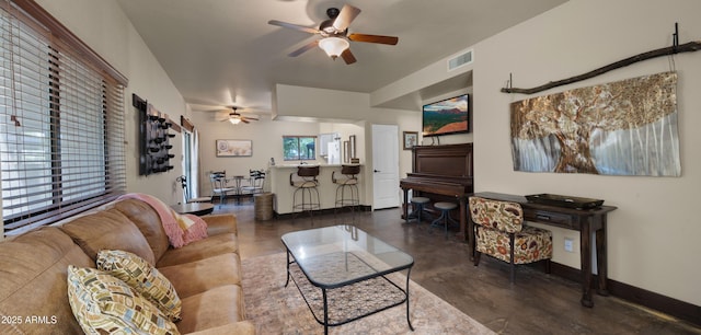 2311 W Dobbins Rd, Phoenix, AZ 85041 - living area featuring ceiling fan, finished concrete floors, and baseboards