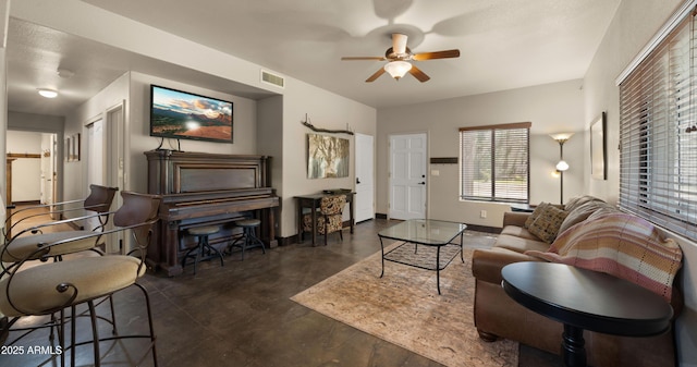2311 W Dobbins Rd, Phoenix, AZ 85041 - living area with ceiling fan, finished concrete flooring, and baseboards