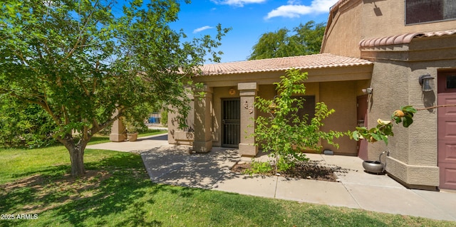 2311 W Dobbins Rd, Phoenix, AZ 85041 - view of front facade with stucco siding, a tiled roof, and a front lawn