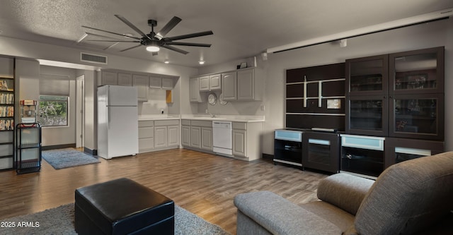 2311 W Dobbins Rd, Phoenix, AZ 85041 - living room with a ceiling fan, wood finished floors, and baseboards