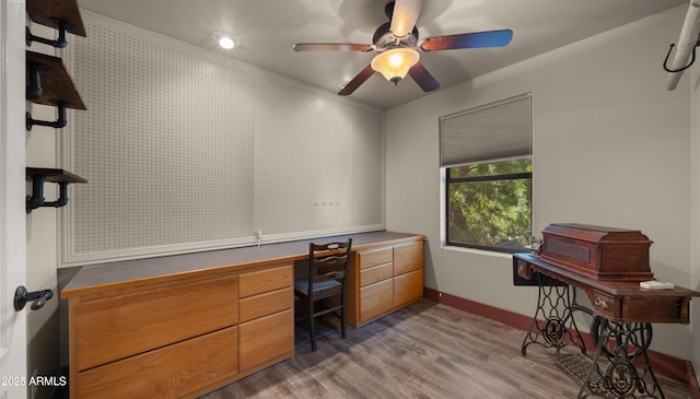 2311 W Dobbins Rd, Phoenix, AZ 85041 - office space featuring light wood-style floors, built in study area, ceiling fan, and baseboards