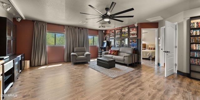2311 W Dobbins Rd, Phoenix, AZ 85041 - living room featuring ceiling fan, wood finished floors, and a textured ceiling