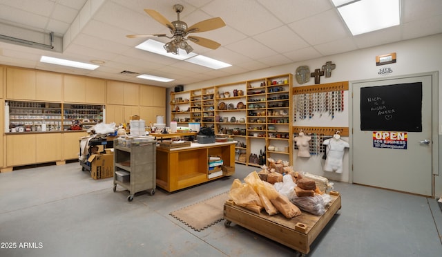 2311 W Dobbins Rd, Phoenix, AZ 85041 - misc room featuring a paneled ceiling, concrete floors, and ceiling fan