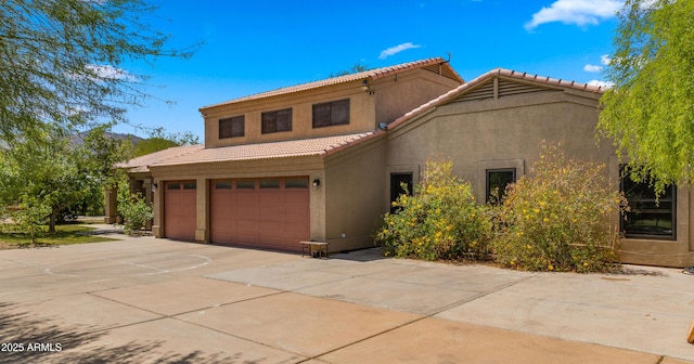 2311 W Dobbins Rd, Phoenix, AZ 85041 - mediterranean / spanish house with stucco siding, a tile roof, a garage, and concrete driveway