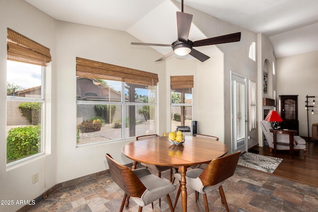 19029 N 36th St, Phoenix, AZ 85050 - dining area featuring vaulted ceiling, ceiling fan, stone finish floors, and baseboards