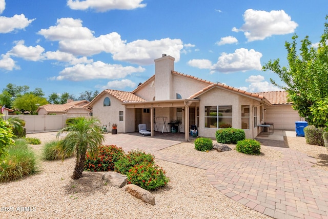 19029 N 36th St, Phoenix, AZ 85050 - back of house featuring fence, a chimney, stucco siding, a tile roof, and a patio