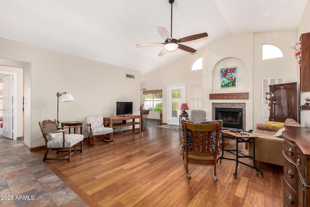 19029 N 36th St, Phoenix, AZ 85050 - living area featuring a ceiling fan, a brick fireplace, high vaulted ceiling, and baseboards
