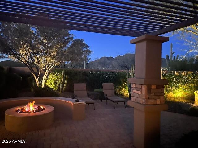 view of patio / terrace with a mountain view, a pergola, and a fire pit