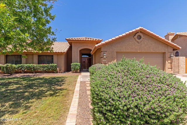 408 W Stacey Ln, Tempe, AZ 85284 - mediterranean / spanish home with an attached garage, a tiled roof, stucco siding, and a front yard