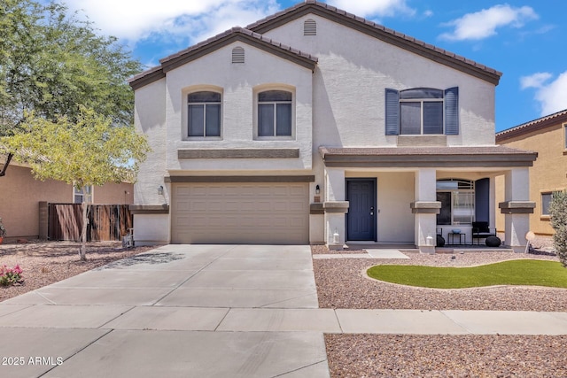 2198 W Pima Ave, Coolidge, AZ 85128 - mediterranean / spanish-style house with an attached garage, concrete driveway, stucco siding, and covered porch