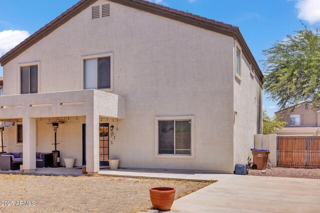 2198 W Pima Ave, Coolidge, AZ 85128 - rear view of property featuring a patio area, stucco siding, and an outdoor hangout area
