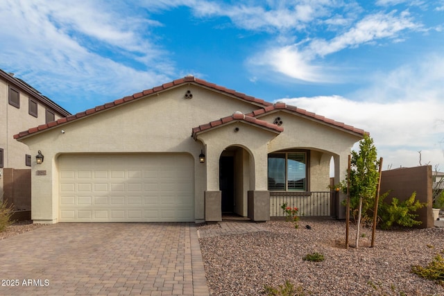 mediterranean / spanish home featuring a garage