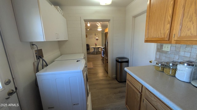 kitchen with washer and dryer, light countertops, dark wood-style floors, and backsplash