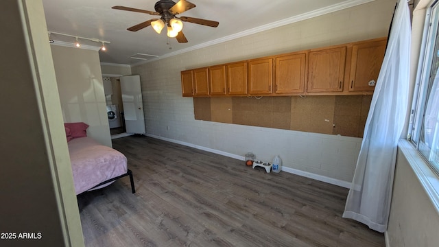 bedroom with attic access, washer / dryer, ceiling fan, dark wood-type flooring, and crown molding