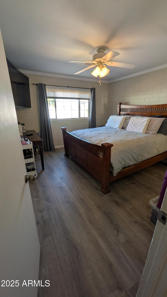 bedroom with wood finished floors, a ceiling fan, and ornamental molding