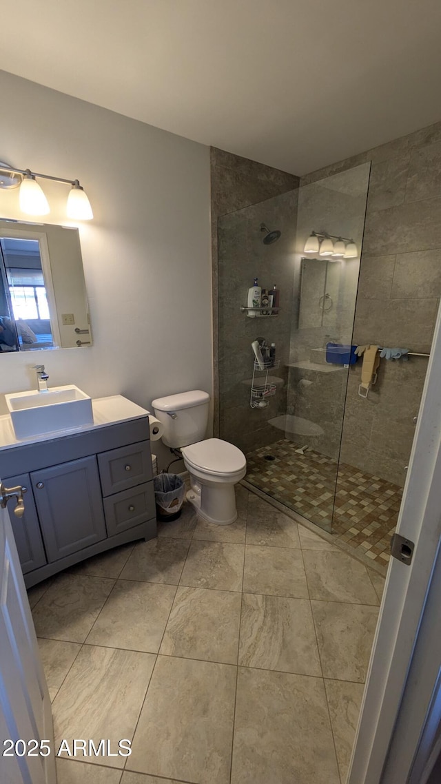 full bathroom with toilet, walk in shower, and vanity