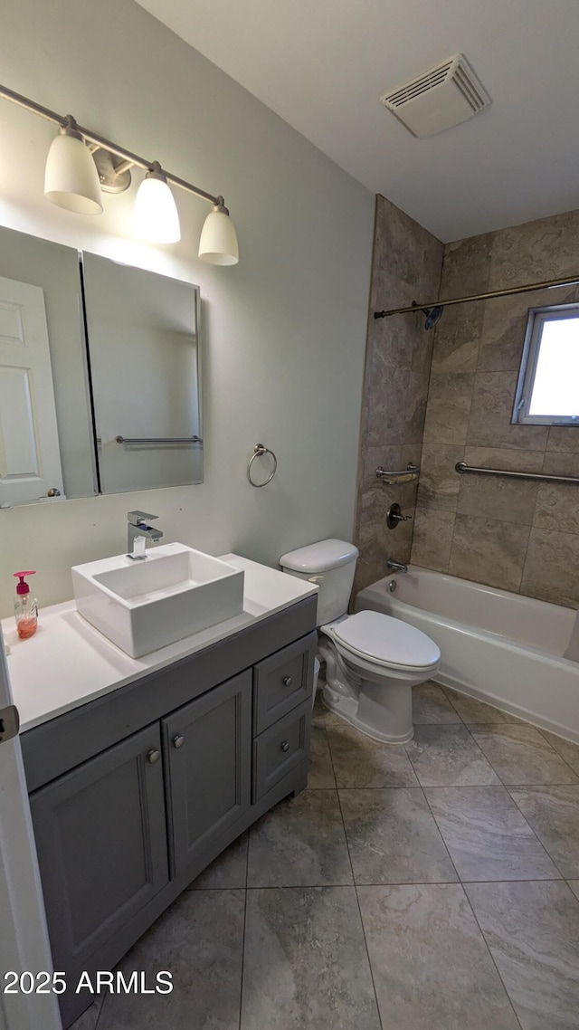 bathroom featuring visible vents, shower / washtub combination, vanity, and toilet