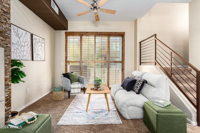 living room featuring ceiling fan and carpet