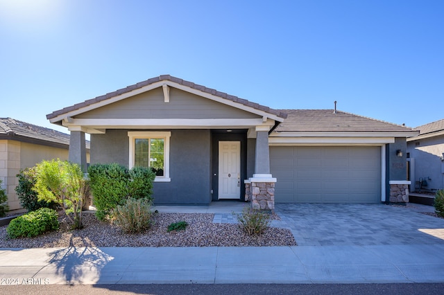 ranch-style house with a porch and a garage