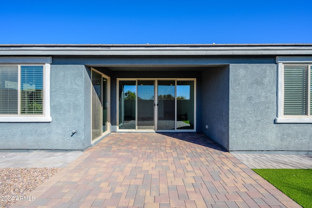 doorway to property with a patio area