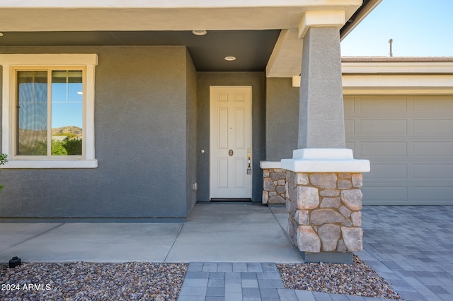 doorway to property with a garage