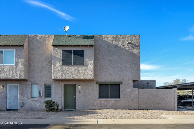 townhome / multi-family property with a carport