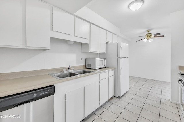 kitchen featuring white appliances, ceiling fan, sink, light tile patterned floors, and white cabinets