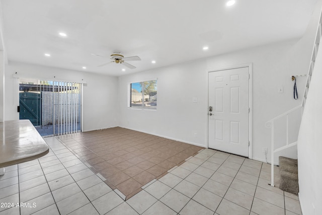 tiled entryway with ceiling fan